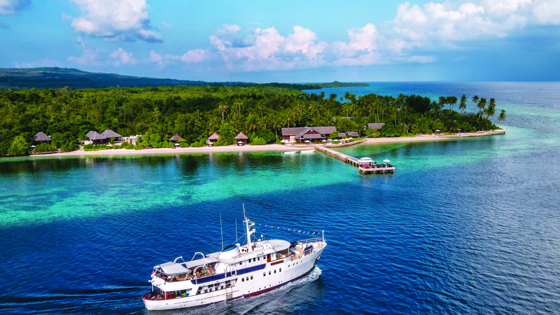 wakatobi resort and house reef; pelagian on the way out for a week-long cruise to buton