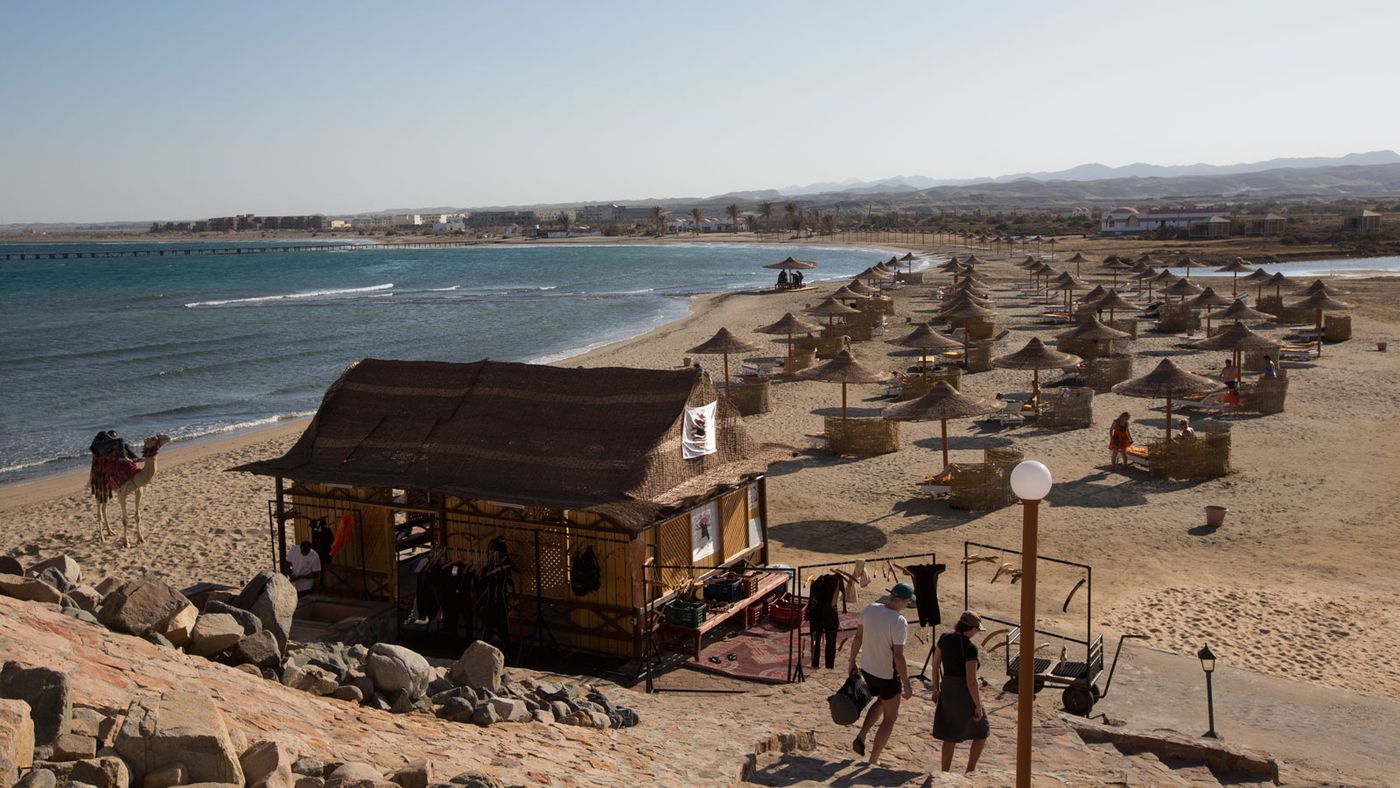 Alles da: Vom Grillrestaurant blickt man einen Hügel hinunter auf einen weiten Strand mit Sonnenschirmen, Strandliegen, dem obligatorischen »Kamel zum Anfassen«, und, last but not least, dem Trockenraum der Tauchbasis.