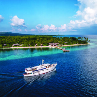 wakatobi resort and house reef; pelagian on the way out for a week-long cruise to buton